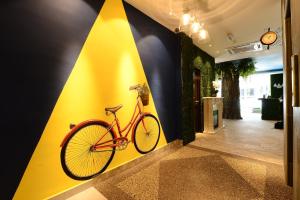 a bike on a yellow wall in a hallway at Hotel de Art USJ 21 in Subang Jaya