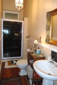 baño con lavabo y aseo y ventana en Anna's Farm Stay, en Slangrivier