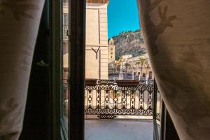a view of a balcony with a view of a building at Kefa Holiday - Palazzo Villelmi in Cefalù