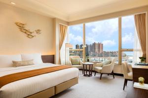 A bed or beds in a room at Hong Kong Gold Coast Hotel