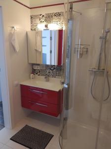 a bathroom with a red sink and a shower at Apartament Eliza in Ustroń +20 photos