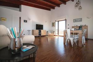 a living room with a table and a dining room at B&B Valleluna in Trani