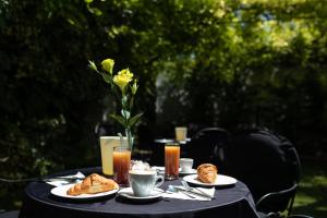 a black table with plates of food on it at Hotel Cavallino Bianco in Cavallino-Treporti