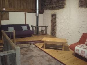 a living room with a couch and a table at domaine de crayeux in Les Champs