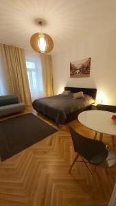 a bedroom with a bed and a table at Angelika Apartments in Vienna