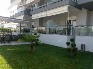a house with a balcony and a yard at Star Studios in Stavros