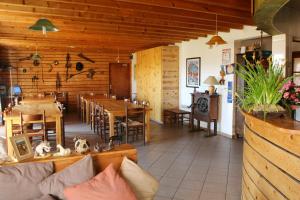 a living room with a table and a dining room at Gîte Equisud - Demi-pension inclus in Les Angles