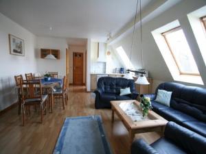 a living room with a couch and a table at Margarethenhof in Tetenbüll