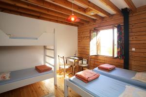 a room with two bunk beds and a desk at Gîte Equisud - Demi-pension inclus in Les Angles