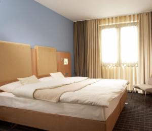 Ліжко або ліжка в номері Qualitel Wilnsdorf