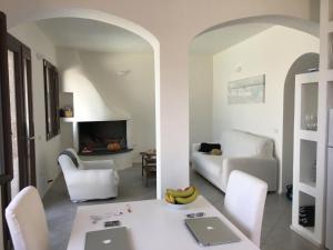 a living room with a table and chairs and a couch at Casa Castel in Castelsardo