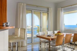 a kitchen and dining room with a table and chairs at Andromeda in Agia Pelagia
