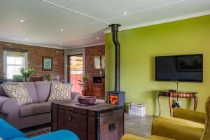 a living room with a couch and a fire place at Springvale Farm in Nottingham Road