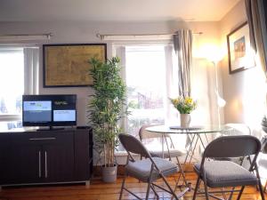 a living room with a table and chairs and a television at Central City - Parking - Great Location -4 Beds in Belfast