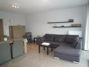 a living room with a couch and a table at Frudor 0401 in Koksijde