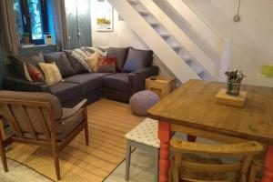 a living room with a couch and a table at Farmhand Cottage in Narberth