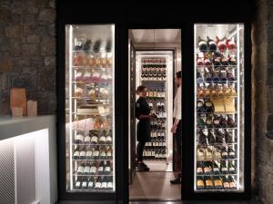 a refrigerator filled with lots of bottles of wine at Bill & Coo Suites and Lounge -The Leading Hotels of the World in Mikonos