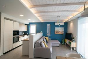 a living room with a couch and a kitchen at Gianni's house in Mastihari