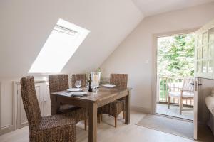 a dining room with a wooden table and chairs at The Loft in Calne