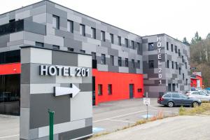a hotel building with a parking lot at Hotel L201 - 24h self-check in in Gablitz