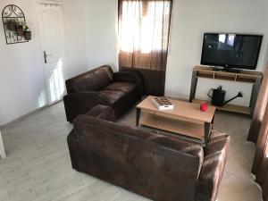 sala de estar con sofá y mesa de centro en LES MAISONS DU PATY en Arlés