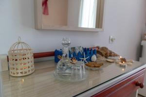 a counter top with cookies and a bird cage on it at Maistrali in Karavostasi