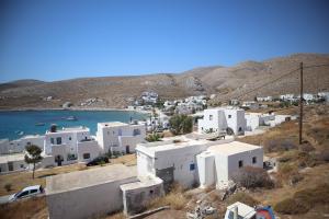 a village with white buildings and a body of water at Maistrali in Karavostasi