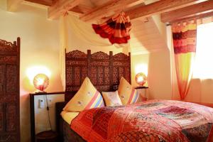 a bedroom with a bed with a wooden head board at Cleo´s Hotel Kallstadt in Kallstadt