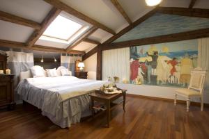 a bedroom with a large painting on the wall at La Villeggiatura in Venice