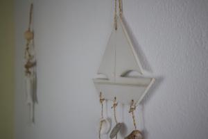 a white shelf with a boat hanging on a wall at Maistrali in Karavostasi