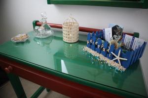 a glass table with books and other items on it at Maistrali in Karavostasi