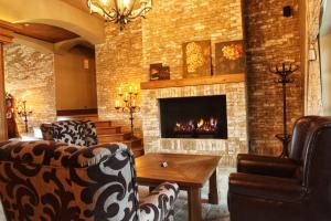 a living room filled with furniture and a fire place at Park Hotel Popovicky in Popovičky