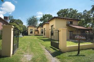 a row of cottages with gates and a sign at Cabañas La Escondida in San Lorenzo