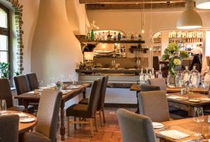 a restaurant with tables and chairs and a bar at Landhaus Diedert in Wiesbaden