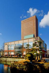 a tall building with a clock on top of it at Daiwa Roynet Hotel Wakayama in Wakayama