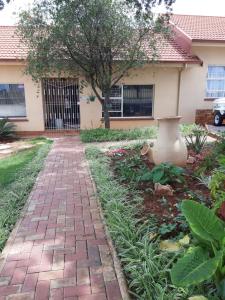 a brick walkway in front of a house at Fochville Guesthouse in Fochville