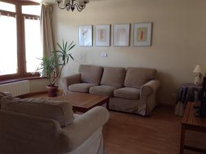 a living room with a couch and a table at Casa de la Tila in Arenas de Cabrales