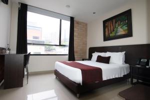 Ένα ή περισσότερα κρεβάτια σε δωμάτιο στο Hotel Acqua Medellín