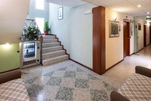 a hallway of a hospital with stairs and a tv at Hotel B&B Euro in Cattolica