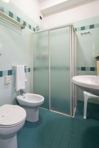 a bathroom with a shower and a toilet and a sink at EURO b&b in Cattolica +22 photos