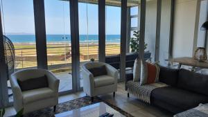 a living room with a view of the ocean at Accommodation Front - Gorgeous 4 Sleeper Beachfront Apartment in Durban