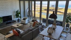 a living room with a couch and a table at Accommodation Front - Gorgeous 4 Sleeper Beachfront Apartment in Durban