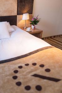 a bed with a white blanket with a panda face on it at Boutique Hotel's in Wrocław