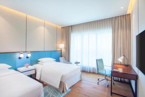 Hyatt Regency Thrissur客房内的一张或多张床位