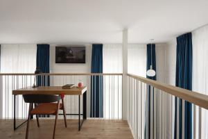 a living room filled with furniture and a window at Hotel Mariënhage in Eindhoven