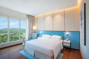Hyatt Regency Thrissur客房内的一张或多张床位