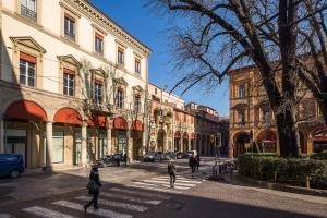 a group of people walking down a city street at B&B Galleria Cavour in Bologna