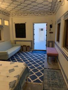 a bedroom with a bed and a doorway with a door at Jaipur Haveli in Jaipur