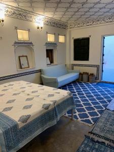 a bedroom with a bed and a mirror at Jaipur Haveli in Jaipur