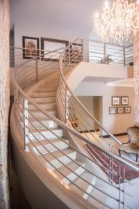 a spiral staircase with a chandelier at Potch Manor Boutique Guest House in Potchefstroom